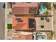 Aerial view showing a rooftop with solar panels, backyard pools and patio furniture at 7957 Lovely Pine Pl, Las Vegas, NV 89143