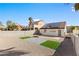 This private backyard features solar panels, artificial turf, and stone landscaping at 7957 Lovely Pine Pl, Las Vegas, NV 89143