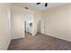 Large bedroom with neutral walls, wood-look floors, and an attached bath at 7957 Lovely Pine Pl, Las Vegas, NV 89143