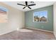 This light, airy bedroom has stylish wood-look floors and a modern ceiling fan at 7957 Lovely Pine Pl, Las Vegas, NV 89143