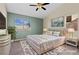 Bright bedroom featuring hardwood floors, large windows, and neutral decor, providing a cozy and inviting space at 7957 Lovely Pine Pl, Las Vegas, NV 89143