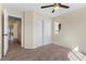 Bedroom with neutral walls, ceiling fan and a double closet at 7957 Lovely Pine Pl, Las Vegas, NV 89143