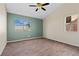 This lovely bedroom features stylish flooring and a modern ceiling fan at 7957 Lovely Pine Pl, Las Vegas, NV 89143