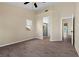 Spacious bedroom with a ceiling fan, wood-look floors, and an attached bath at 7957 Lovely Pine Pl, Las Vegas, NV 89143