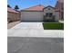 Charming single-story home featuring a well-manicured lawn, a two car garage and a red tile roof at 7957 Lovely Pine Pl, Las Vegas, NV 89143