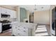 Stylish kitchen with stainless steel appliances, white cabinets, and an island at 7957 Lovely Pine Pl, Las Vegas, NV 89143