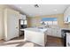 Bright kitchen featuring white cabinets, stainless appliances, and an island with a white countertop at 7957 Lovely Pine Pl, Las Vegas, NV 89143