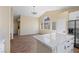 Open-concept living area with a vaulted ceiling, modern light fixture, and lots of natural light at 7957 Lovely Pine Pl, Las Vegas, NV 89143