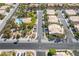 An aerial view of a residential neighborhood features a community pool and well-maintained landscaping around the houses at 7985 Simone Ave, Las Vegas, NV 89147