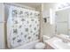 Standard bathroom with shower-tub combo, vanity, and a palm tree shower curtain at 7985 Simone Ave, Las Vegas, NV 89147