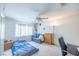 Well-lit bedroom with carpet, ceiling fan, and standard furnishings at 7985 Simone Ave, Las Vegas, NV 89147