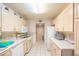 Well-lit kitchen with white cabinets, ample counter space, and essential appliances at 7985 Simone Ave, Las Vegas, NV 89147