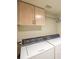 Laundry area with a washer, dryer, and cabinet space for storage at 7985 Simone Ave, Las Vegas, NV 89147