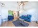 Open living space with wood laminate flooring, a ceiling fan, and stairs to the upper level at 7985 Simone Ave, Las Vegas, NV 89147