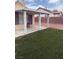 Backyard featuring grass, a brick wall, a covered patio with a chair at 807 Airy Hill St, Henderson, NV 89015