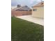 Backyard features artificial turf, brick wall, concrete slab, stacked cinder blocks at 807 Airy Hill St, Henderson, NV 89015