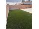 Backyard with grass, brick wall, a concrete slab, and stacked cinder blocks at 807 Airy Hill St, Henderson, NV 89015