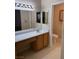 Bathroom featuring a single sink vanity, a large mirror, and a toilet in a separate alcove at 807 Airy Hill St, Henderson, NV 89015