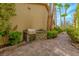Exterior view of stone barbecue area with brick pavers and mature landscaping at 8199 Pinnacle Peak Ave, Las Vegas, NV 89113