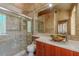 Bathroom featuring a tiled walk-in shower with glass door, modern sink, and custom tile design at 8199 Pinnacle Peak Ave, Las Vegas, NV 89113