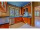 Stylish kitchen with wood cabinets, black countertops, and a stainless steel dishwasher at 8199 Pinnacle Peak Ave, Las Vegas, NV 89113