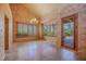 Elegant living room with large windows, a chandelier, and access to the patio at 8199 Pinnacle Peak Ave, Las Vegas, NV 89113