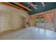 Spacious living room with vaulted ceiling, wooden beams, ceiling fan and glass doors to outdoor space at 8199 Pinnacle Peak Ave, Las Vegas, NV 89113