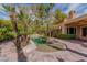 Landscaped backyard pool and spa with mature trees and well-maintained brick pavers at 8199 Pinnacle Peak Ave, Las Vegas, NV 89113