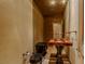 Unique powder room with a modern sink, stone accent wall, dark fixtures, and black toilet at 8199 Pinnacle Peak Ave, Las Vegas, NV 89113