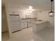 Bright kitchen featuring white cabinetry, granite counters, and modern appliances at 833 Hedge Way # 2, Las Vegas, NV 89110