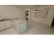 Bright kitchen featuring white cabinetry, granite counters, and laundry machines at 833 Hedge Way # 2, Las Vegas, NV 89110