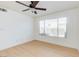 Bright bedroom featuring a ceiling fan, a large window, and light laminate flooring at 8450 Alta Dr # 136, Las Vegas, NV 89145