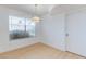 Bright dining room with modern light fixture and wood laminate flooring at 8450 Alta Dr # 136, Las Vegas, NV 89145