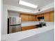 Kitchen with wood cabinets and stainless steel appliances at 8450 Alta Dr # 136, Las Vegas, NV 89145