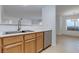 Bright kitchen featuring wooden cabinets and stainless steel dishwasher at 8450 Alta Dr # 136, Las Vegas, NV 89145