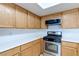 Bright kitchen featuring wooden cabinets, stainless steel oven, and microwave at 8450 Alta Dr # 136, Las Vegas, NV 89145