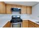 Bright kitchen featuring wooden cabinets, stainless steel oven, and microwave at 8450 Alta Dr # 136, Las Vegas, NV 89145
