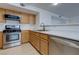 Bright kitchen featuring wooden cabinets, stainless steel oven and dishwasher at 8450 Alta Dr # 136, Las Vegas, NV 89145