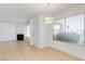 Open living room with fireplace, window, and light laminate flooring at 8450 Alta Dr # 136, Las Vegas, NV 89145