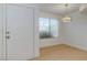 Bright living room featuring an entry door and large window at 8450 Alta Dr # 136, Las Vegas, NV 89145