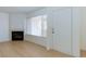 Living room featuring a fireplace, large window, and entry door at 8450 Alta Dr # 136, Las Vegas, NV 89145