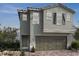 Charming two-story home with an attached garage and stone veneer detailing at 9095 Rivington Ave, Las Vegas, NV 89148
