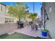 Home's backyard featuring a patio with outdoor furniture and a grill, perfect for entertaining at 9157 Acclamation Ct, Las Vegas, NV 89149