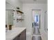 Bathroom with shelving, modern vanity, walk-in shower, and view to the bedroom at 9157 Acclamation Ct, Las Vegas, NV 89149