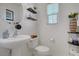 Cozy half bathroom featuring a stylish sink, toilet, and decorative shelving at 9157 Acclamation Ct, Las Vegas, NV 89149