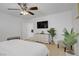 Well-lit bedroom showcases modern decor, dresser, TV, and stylish furniture at 9157 Acclamation Ct, Las Vegas, NV 89149