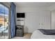 Bright bedroom featuring balcony access, wall-mounted TV, and closet space at 9157 Acclamation Ct, Las Vegas, NV 89149
