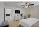 Bright bedroom with a TV, white dresser, ceiling fan, and view into the hall at 9157 Acclamation Ct, Las Vegas, NV 89149