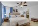 Bedroom features a large bed, blue curtains, ceiling fan, and access to ensuite at 9157 Acclamation Ct, Las Vegas, NV 89149