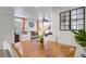 Open-concept dining area showcases a polished wood table and stylish seating at 9157 Acclamation Ct, Las Vegas, NV 89149